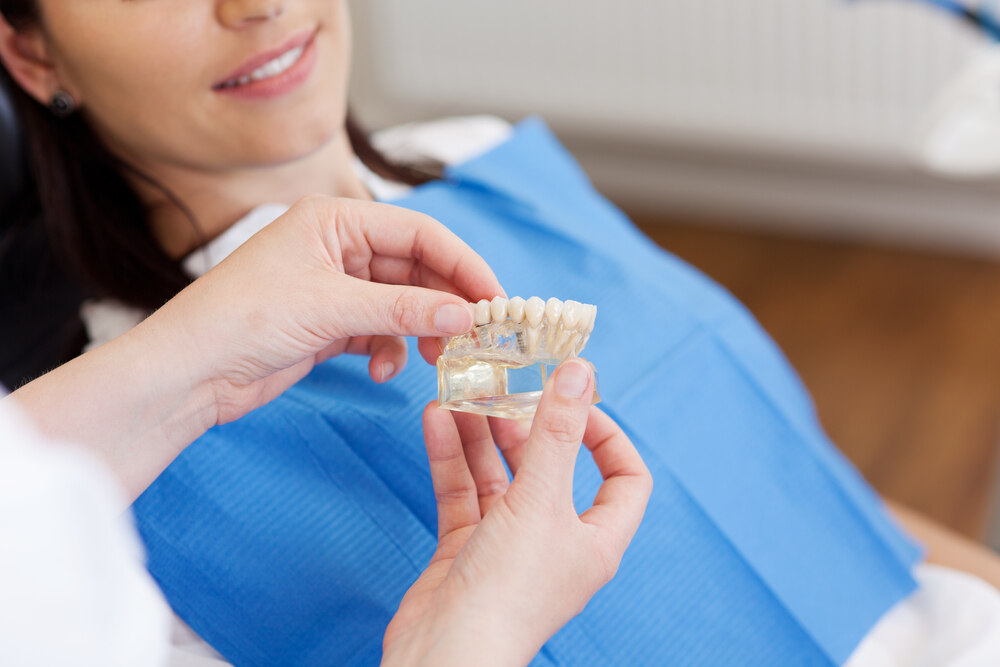 A dentist explaining dental inlays and onlays to a patient